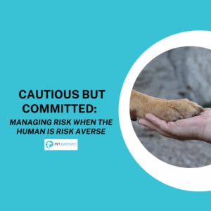 A picture of a human hand holding a dog paw. Text reads: Cautious But Committed: Managing Risk When the Human is Risk Averse