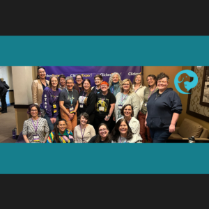 A group of people in front of banner for Clicker Expo (Karen Pryor Training Academy)