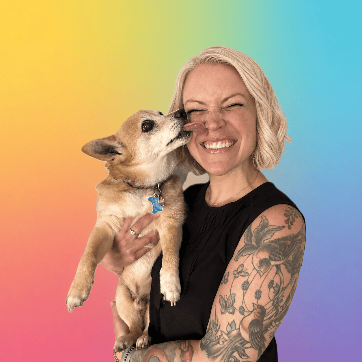 A woman holding a small dog with a rainbow background. Valerie Bogie, Veterinary Social Worker.