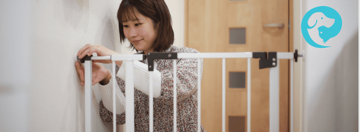 A woman installing a baby gate. Preparing home for dog and baby.
