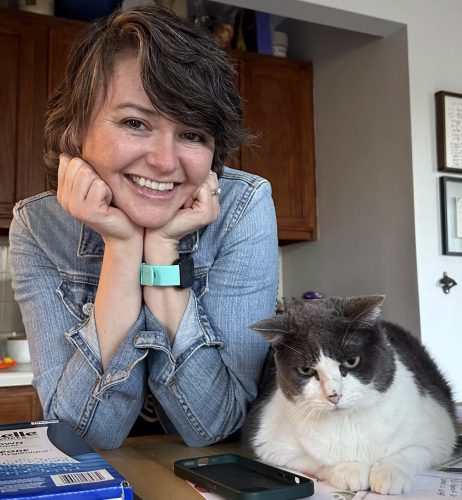 Corinne Collier, CPDT-KA posing next to a Naperville client's cat.